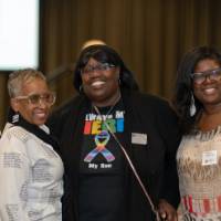 A group of four women pose for a photo
